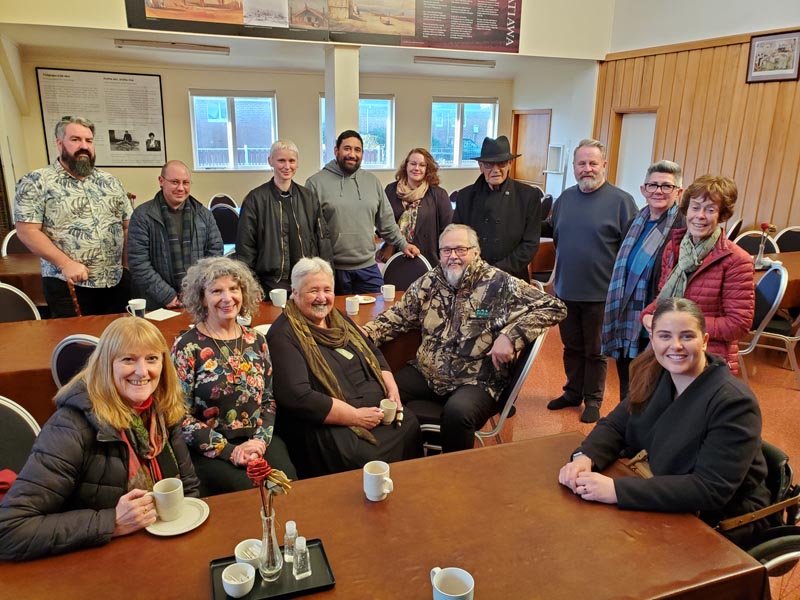 Arts Access Aotearoa staff, board members and Kaumātua the late Bill Kaua around a table at Waiwhetū  Marae 